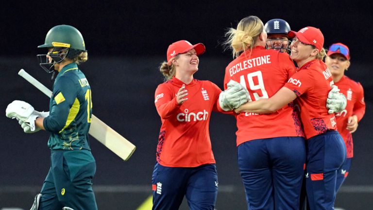 England's players celebrate after dismissing Australia's Beth Mooney during their Women's Ashes T20 cricket match in Canberra, Thursday, Jan. 23, 2025. (Mick Tsikas/AAP Image via AP)