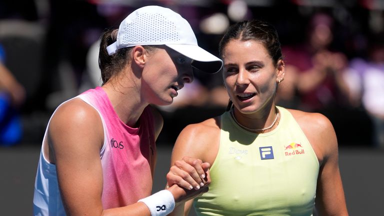 Iga Swiatek, left, of Poland, is congratulated by Emma Navarro of the United States after their quarterfinal match at the Australian Open, Wednesday, Jan. 22, 2025. (AP Photo/Asanka Brendon Ratnayake)