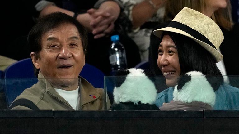 Actor Jackie Chan, left, reacts as he watches Aryna Sabalenka of Belarus play Madison Keys of the U.S. during the women's singles final at the Australian Open tennis championship in Melbourne, Australia, Saturday, Jan. 25, 2025. (AP Photo/Ng Han Guan)