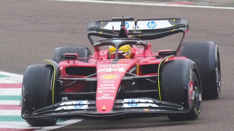 British driver Lewis Hamilton waves to fans as he steers a Ferrari Formula One SF-23 at the Ferrari private test track, in Fiorano Modenese, Italy, Wednesday, Jan. 22, 2025. (AP Photo/Luca Bruno)