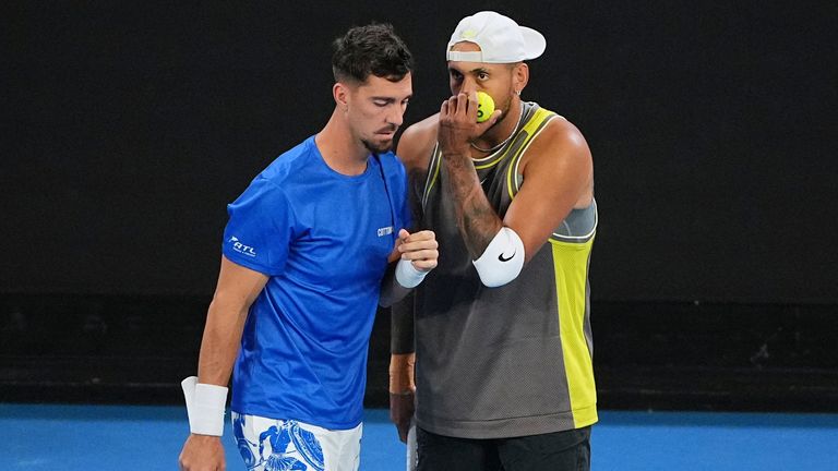 Australia's Nick Kyrgios, right, and Thanasi Kokkinakis talk during their first round double match against compatriots James Duckworth and Aleksandar Vukic at the Australian Open tennis championship in Melbourne, Australia, Thursday, Jan. 16, 2025. (AP Photo/Vincent Thian)