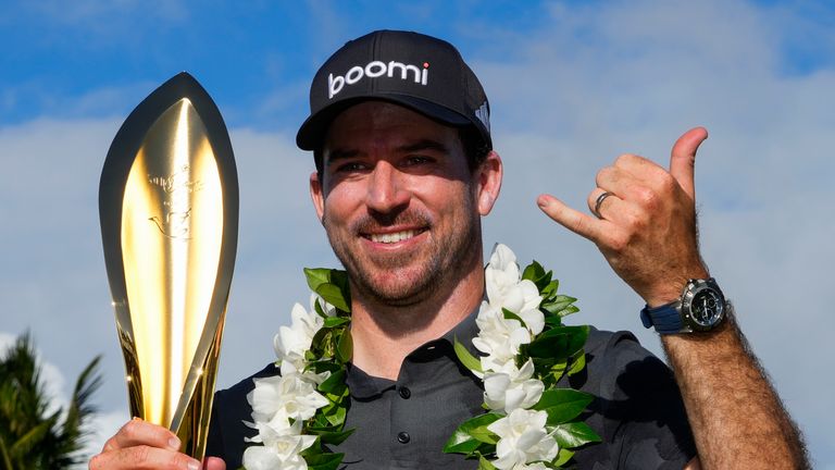 Nick Taylor, of Canada, poses with his trophy after winning the Sony Open golf event, Sunday, Jan. 12, 2025, at Waialae Country Club in Honolulu. (AP Photo/Matt York)