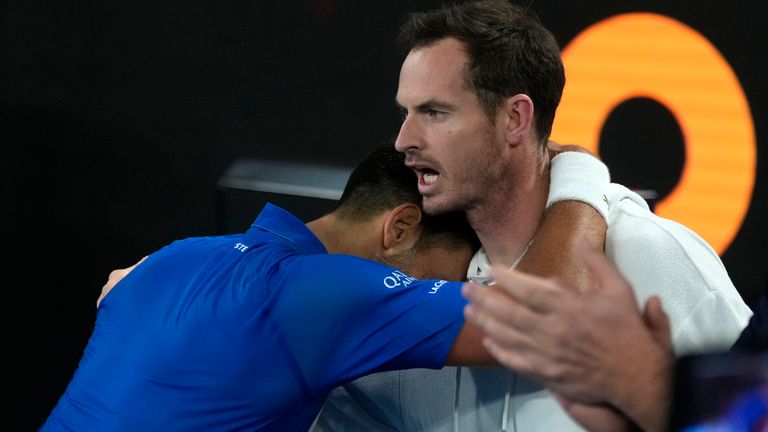 Novak Djokovic of Serbia celebrates with coach Andy Murry, right, after defeating Carlos Alcaraz of Spain in their quarterfinal match at the Australian Open tennis championship in Melbourne, Australia, early Wednesday, Jan. 22, 2025. (AP Photo/Asanka Brendon Ratnayake)