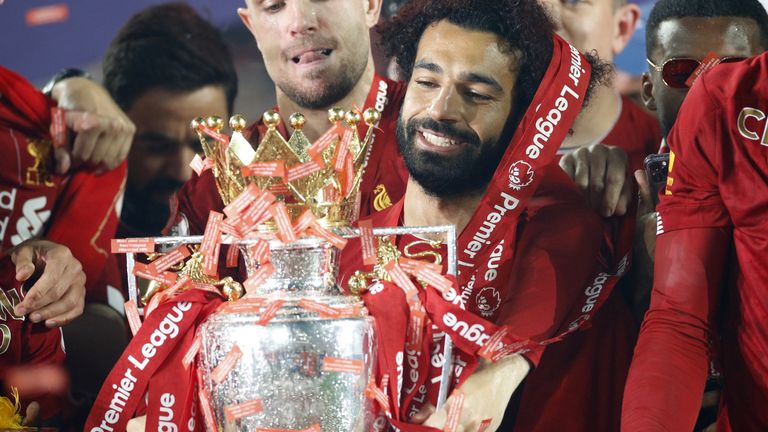 Liverpool's Mohamed Salah celebrates with the Premier League trophy