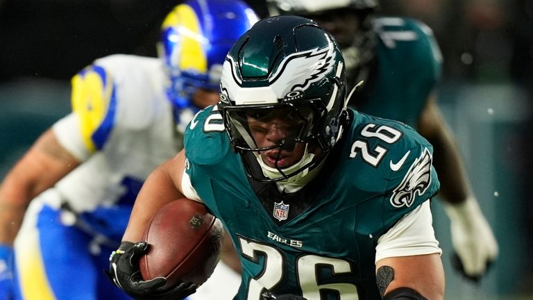 Philadelphia Eagles running back Saquon Barkley (26) runs the ball for a touchdown during the first half of an NFL football NFC divisional playoff game against the Los Angeles Rams on Sunday, Jan. 19, 2025, in Philadelphia. (AP Photo/Chris Szagola)