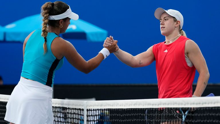 Sonay Kartal, right, of Britain congratulates Jessica Bouzas Maneiro of Spain following their first round match at the Australian Open tennis championship in Melbourne, Australia, Sunday, Jan. 12, 2025. (AP Photo/Manish Swarup)