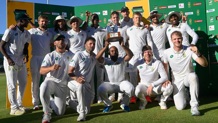 South Africa's Temba Bavuma (C) holds up the trophy after winning the Test match series, following the fourth day of the second international Test cricket match between South Africa and Pakistan, at Newlands stadium in Cape Town on January 6, 2025. (Photo by Rodger Bosch / AFP)