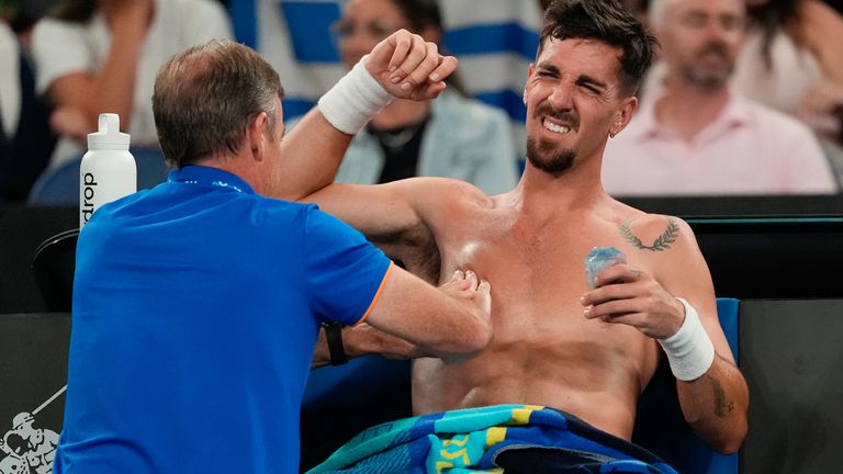 Thanasi Kokkinakis of Australia receives treatment during their second round match against Jack Draper of Great Britain during the Australian Open tennis championships, Wednesday, Jan. 15, 2025. (AP Photo/Asanka Brendon Ratnayake)