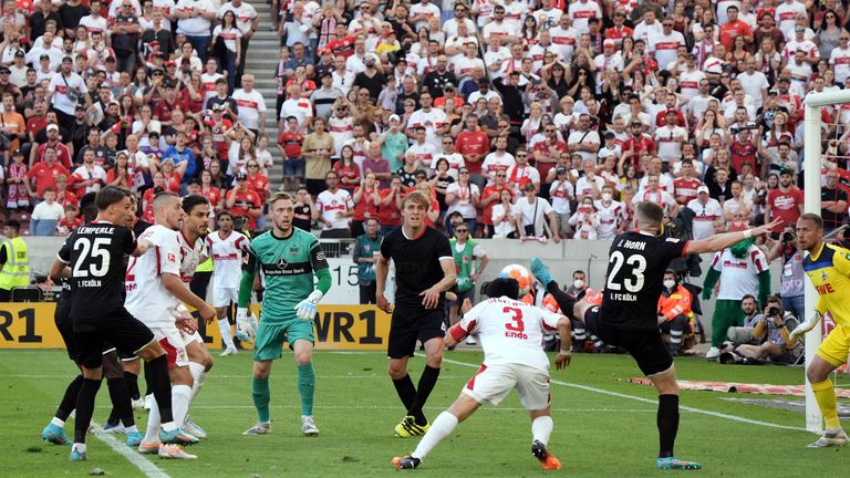 Wataru Endo of VfB Stuttgart scores their team's second goal past Marvin Schwaebe of 1.FC Koeln during the Bundesliga match between VfB Stuttgart and 1. FC Köln at Mercedes-Benz Arena on May 14, 2022 in Stuttgart, Germany