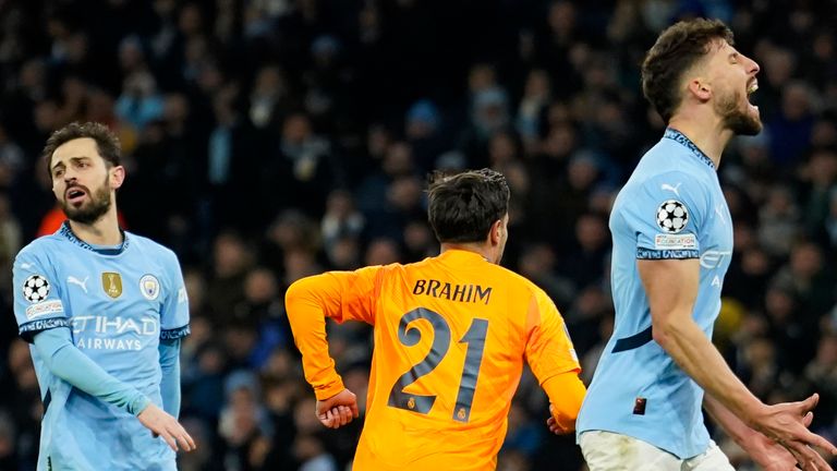 Real Madrid's Brahim Diaz, center, runs to celebrate after scoring his sides second goal during the Champions League playoff first leg soccer match between Manchester City and Real Madrid at the Etihad Stadium in Manchester, England, Tuesday, Feb. 11, 2025. (AP Photo/Dave Thompson)