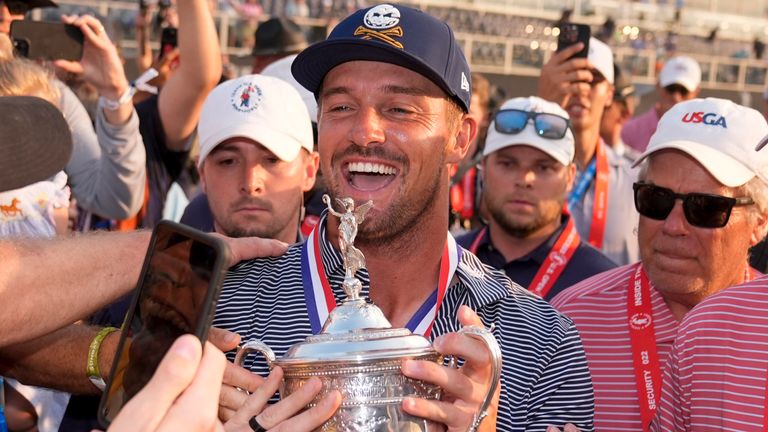 FILE - Bryson DeChambeau celebrates with fans and the trophy after winning the U.S. Open golf tournament Sunday, June 16, 2024, in Pinehurst, N.C. (AP Photo/Frank Franklin II, File)