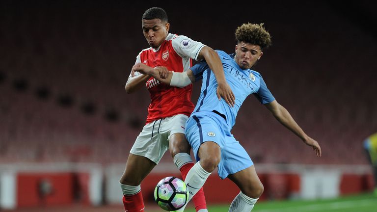 Donyell Malen of Arsenal tussles for the ball with Manchester City's Jadon Sancho at Emirates Stadium on March 13, 2017 in London, England.