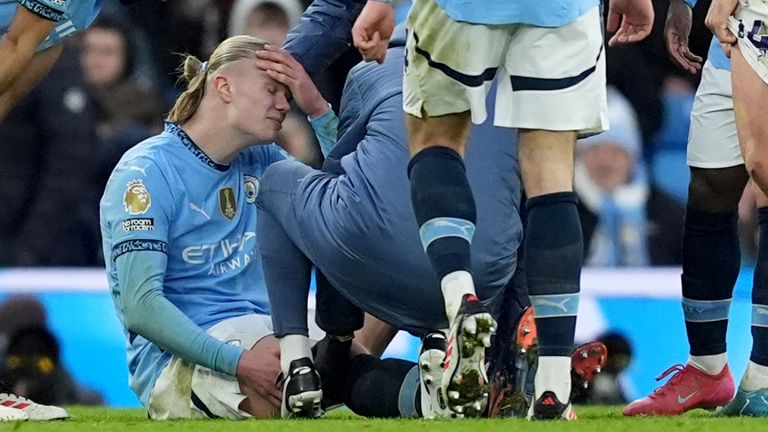 Erling Haaland receives treatment after going to ground