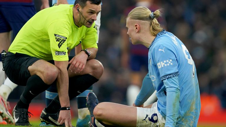 Referee Andy Madley checks on Erling Haaland after the Man City striker went down injured (AP Photo/Ian Hodgson)