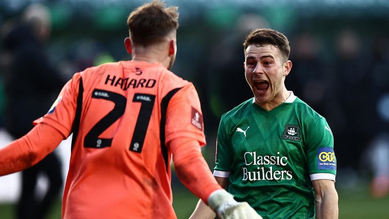 Plymouth players Conor Hazard Adam Randell celebrate victory over Liverpool