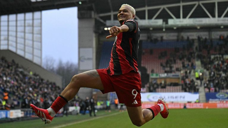 Rodrigo Muniz leaps in celebration after restoring Fulham's lead at Wigan