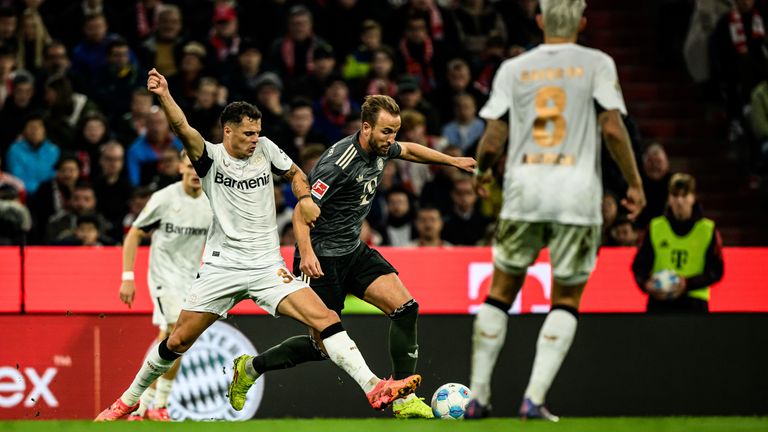 MUNICH, GERMANY - SEPTEMBER 28: Granit Xhaka of Bayer 04 Leverkusen and Harry Kane of FC Bayern M..nchen compete for the ball during the Bundesliga match between FC Bayern M..nchen and Bayer 04 Leverkusen at Allianz Arena on September 28, 2024 in Munich, Germany. (Photo by Sebastian Widmann/Bundesliga/Bundesliga Collection via Getty Images)