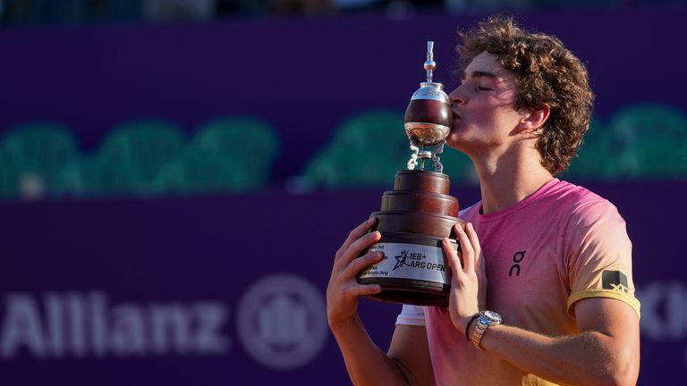 Joao Fonseca poses with the trophy after beating Francisco Cerundolo to win the Argentina Open