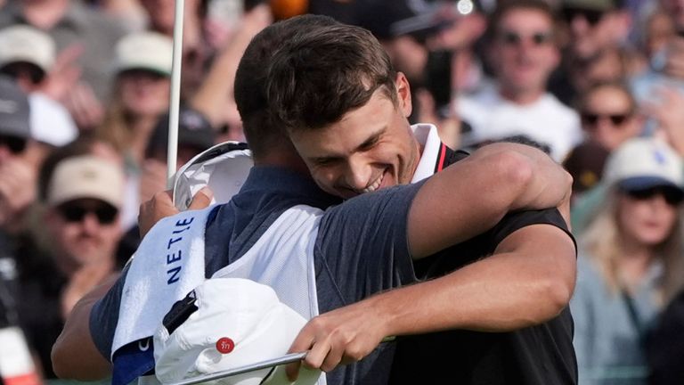 Ludvig ..berg, of Sweden, right, celebrates after making a birdie putt on the 18th green of the South Course at Torrey Pines during the final round of the Genesis Invitational golf tournament Sunday, Feb. 16, 2025, in San Diego. (AP Photo/Gregory Bull)