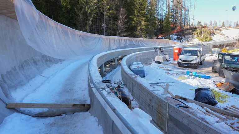 Construction work takes place at the Cortina Sliding Center, venue for the bob, luge and skeleton disciplines at the Milan Cortina 2026 Winter Olympics, in Cortina d'Ampezzo, Italy, Thursday, Jan. 16, 2025. (AP Photo/Giovanni Auletta)