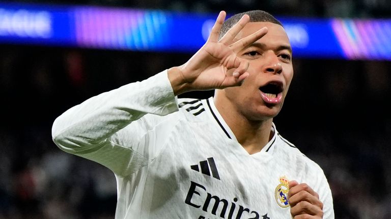 Real Madrid's Kylian Mbappe celebrates with Real Madrid's Jude Bellingham, right, after scoring his sides third goal during the Champions League playoff second leg soccer match between Real Madrid and Manchester City at the Santiago Bernabeu Stadium in Madrid, Spain, Wednesday, Feb. 19, 2025. (AP Photo/Manu Fernandez)