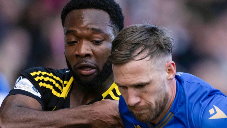 PERTH, SCOTLAND - MARCH 15: Aberdeen's Shayden Morris and St. Johnstone's Barry Douglas in action during a William Hill Premiership match between St Johnstone and Aberdeen at McDiarmid Park, on March 15, 2025, in Perth, Scotland.  (Photo by Paul Devlin / SNS Group)