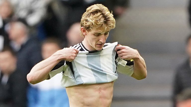 Newcastle United's Anthony Gordon leaves the pitch after being shown a red card