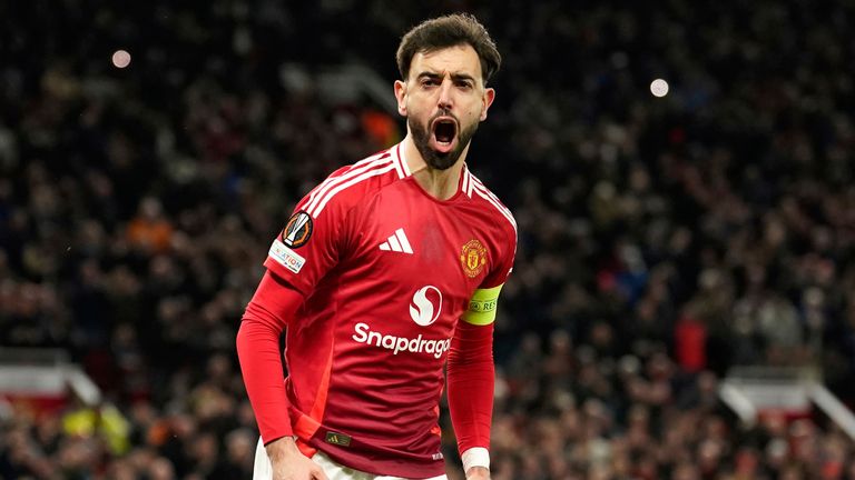 Manchester United's Bruno Fernandes celebrates scoring his side's first goal during the Europa League soccer match between Manchester United and Real Sociedad at Old Trafford stadium in Manchester, England, Thursday, March 13, 2025 . (AP Photo/Dave Thompson)