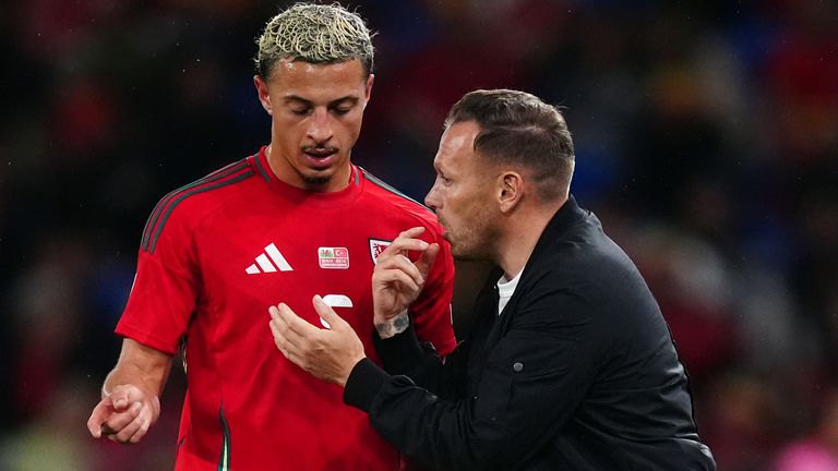 Ethan Amapdu, pictured with Craig Bellamy during the September internationals, is injured for Wales' upcoming games