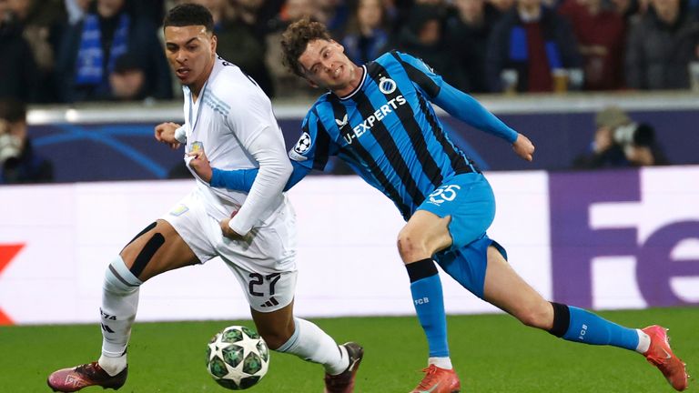 Aston Villa's Morgan Rogers, left, fights for the ball with Brugge's Maxim De Cuyper during the Champions League round of 16 first leg