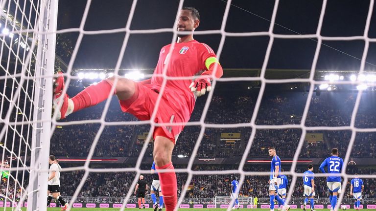 Italy's goalkeeper #01 Gianluigi Donnarumma kicks the goal post in frustration after conceding the 2-0 goal during the UEFA Nations League quarter-final second leg football match Germany v Italy at the Signal Iduna Park stadium in Dortmund, western Germany on March 23, 2025. (Photo by Kirill KUDRYAVTSEV / AFP)