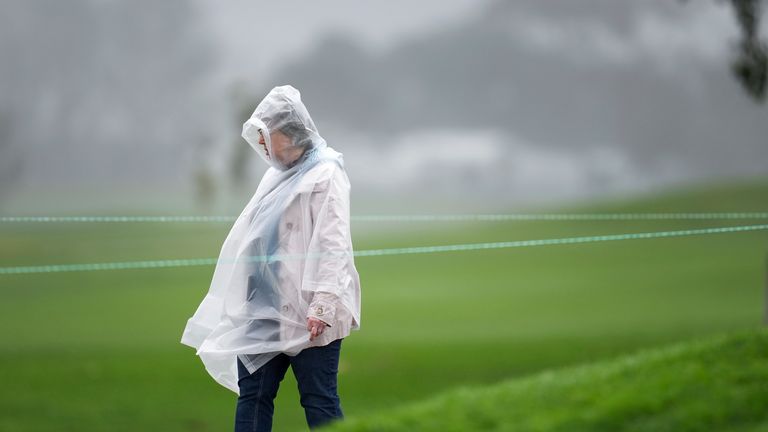 A spectator wears a rain pancho on the second hole of the South Course at Torrey Pines during the first round of the Genesis Invitational golf tournament Thursday, Feb. 13, 2025, in San Diego. (AP Photo/Gregory Bull)