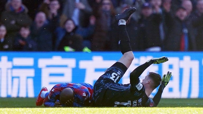 Jean-Philippe Matthery of Crystal Palace lies damaged after a high boot from Millwall Liam Roberts goalkeeper