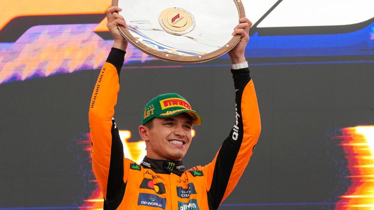 McLaren driver Lando Norris celebrates on the podium winning the Australian Grand Prix
