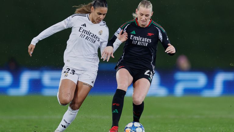 Real Madrid's Maelle Lakrar, left, challenges for the ball with Arsenal's Stina Blackstenius during the Women's Champions League quarterfinal first leg soccer match between Real Madrid and Arsenal at the Alfredo di Stefano stadium in Madrid, Spain, Tuesday March 18, 2025. (AP Photo/Fran Berg)