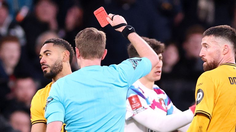 Mathues Cunha is shown a red card by referee Chris Kavanagh after clashing with Bournemouth's Milos Kerkez