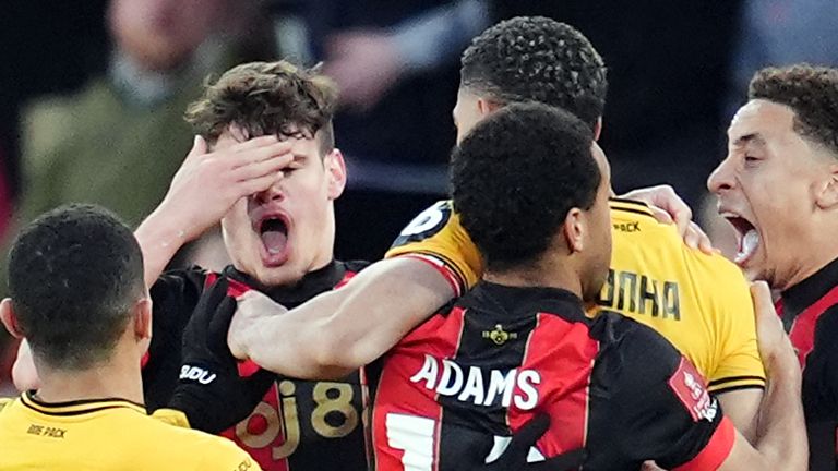 Milos Kerkez holds his forehead after clashing with Matheus Cunha during extra time