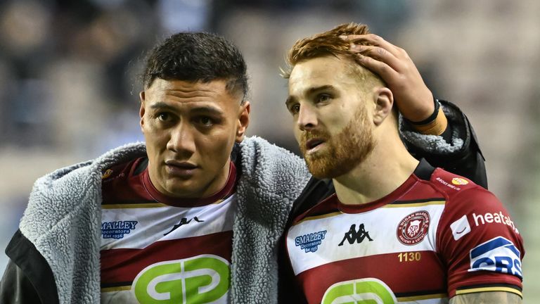 Wigan Warriors' Patrick Mago (L)  comforts Adam Keighran (R) following their shock defeat to Hull FC