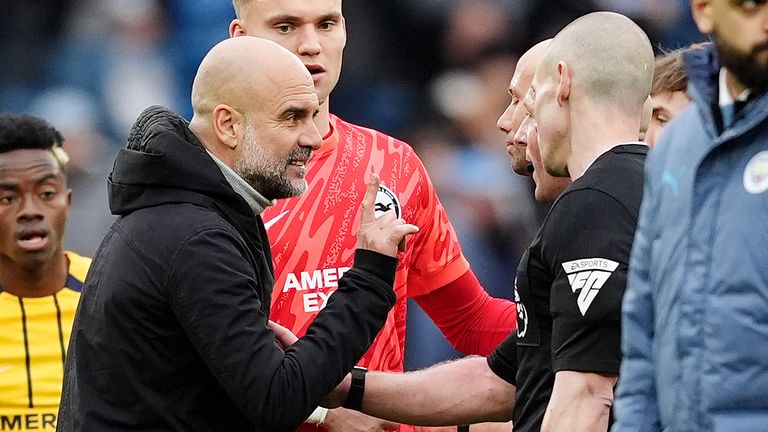 Pep Guardiola speaks with referee Simon Hooper at full time