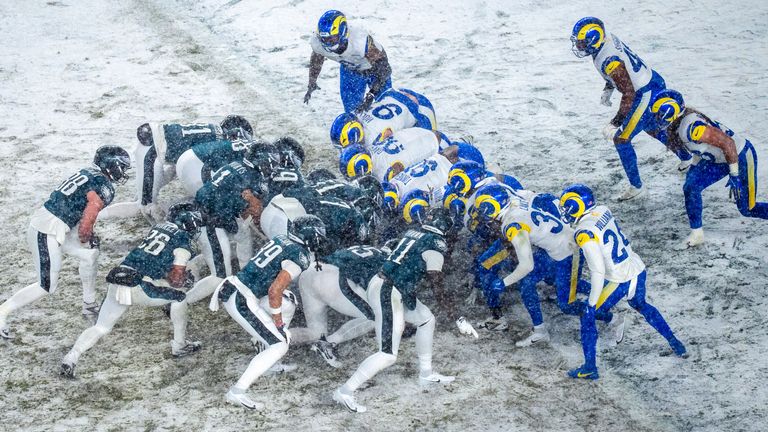 Philadelphia Eagles quarterback Jalen Hurts (1) lines the team up for a Tush Push attempt during the NFL divisional playoff football game against the Los Angeles Rams, Sunday, Jan. 19, 2025, in Philadelphia. (AP Photo/Chris Szagola)