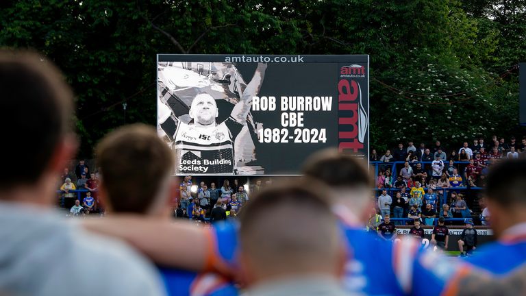 Picture by Allan McKenzie/SWpix.com - 21/06/2024 - Rugby League - Betfred Super League Round 15 - Leeds Rhinos v Leigh Leopards - AMT Headingley, Leeds, England - Leeds players stand for a minute's applause as they remember Rob Burrow.