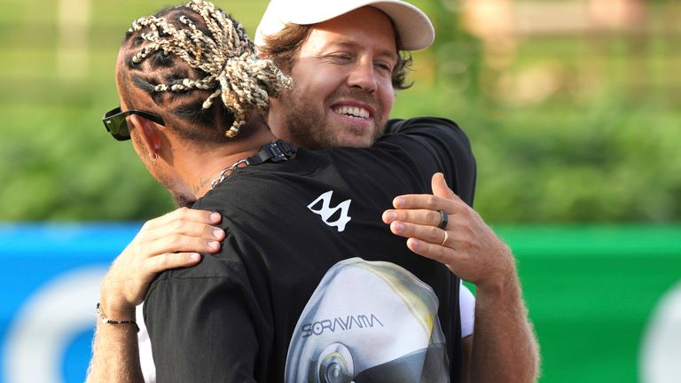 Sebastian Vettel and Lewis Hamilton embrace at Suzuka in 2023