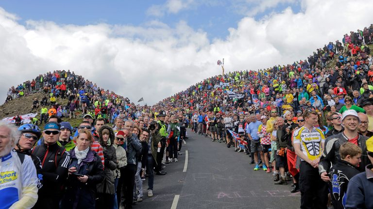 Spectators wait for the cyclists to climb Buttertubs pass during the first stage of the Tour de France cycling race in 2014, beginning in Leeds and finishing in Harrogate