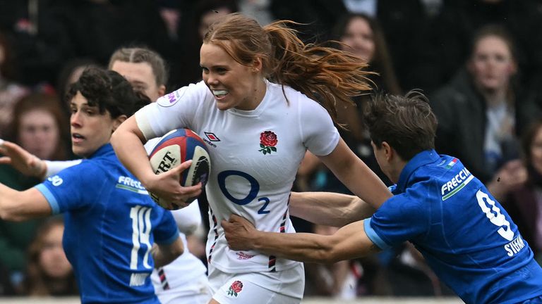 England's wing Mia Venner (C) holds off Italy's scrum-half Sofia Stefan (R) during the Women's Six Nations international rugby union match between England and Italy at the LNER Community Stadium in York, northern England on March 23, 2025. (Photo by Paul ELLIS / AFP)