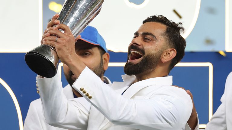 India's Virat Kohli celebrates with ICC Champions Trophy (Associated Press)