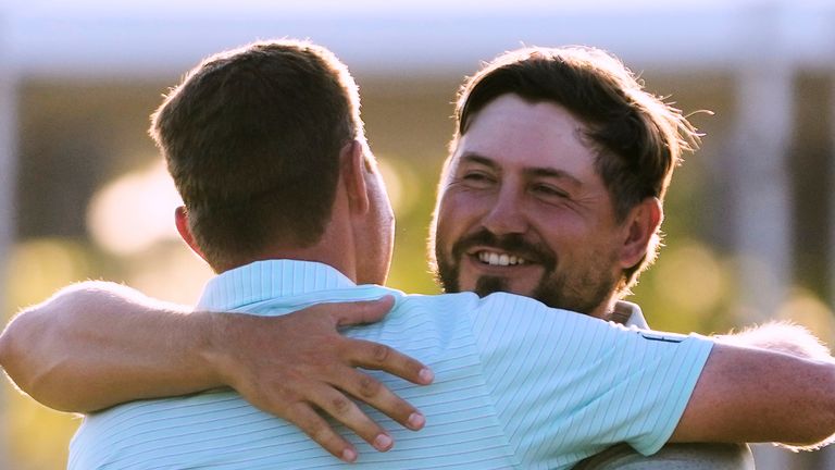 Andrew Novak, facing, embraces teammate Ben Griffin on the 18th green after they won the PGA Zurich Classic golf tournament at TPC Louisiana in Avondale, La., Sunday, April 27, 2025. (AP Photo/Gerald Herbert)