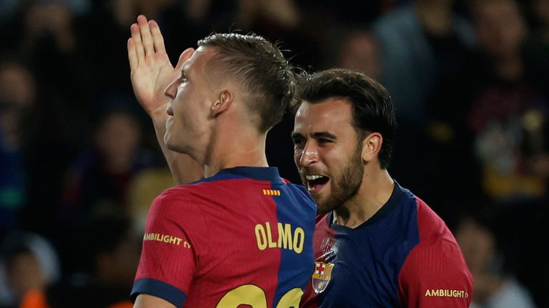 Barcelona's Dani Olmo, left, celebrates with scoring his side's opening goal during a Spanish La Liga soccer match between Barcelona and Mallorca at the Lluis Companys Olympic stadium in Barcelona, Spain, Tuesday, April 22, 2025. (AP Photo/Joan Monfort)