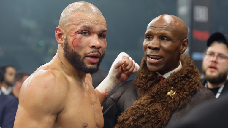 Chris Eubank Jr celebrates his victory with his father. Pic: Lawrence Lustig / Boxxer