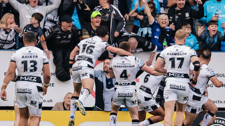 Davy Litten of Hull FC celebrates with team-mates after scoring a try.