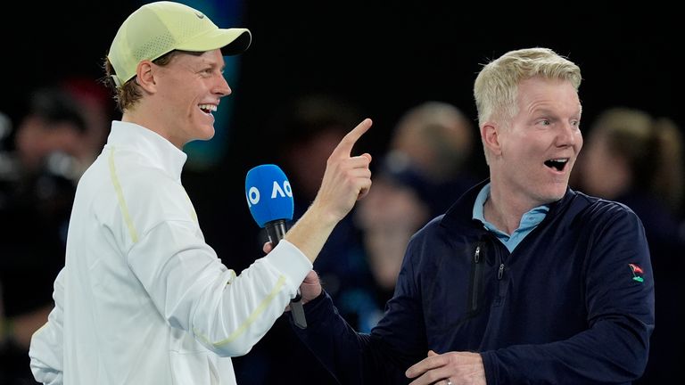 Jannik Sinner of Italy reacts as he is interviewed by Jim Courier after defeating Ben Shelton of the U.S. in their semifinal match at the Australian Open tennis championship in Melbourne, Australia, Friday, Jan. 24, 2025. (AP Photo/Asanka Brendon Ratnayake)